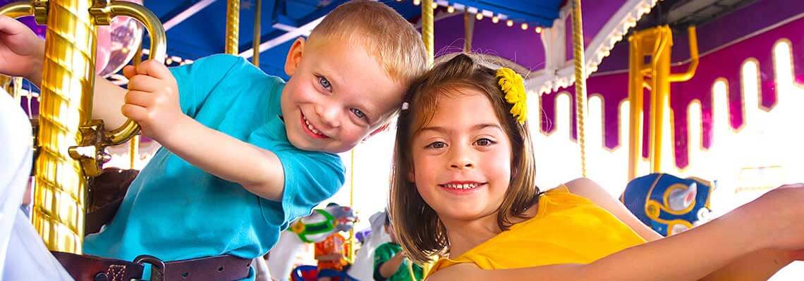 Children riding a merry go round